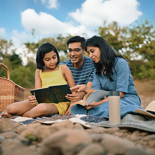 Family reading together on beach